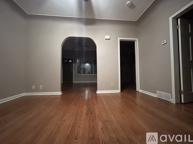 A room with wooden floors and a ceiling fan.