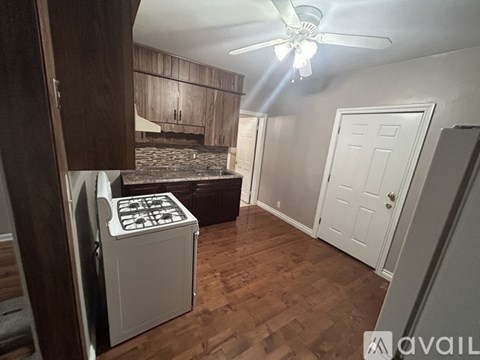 A kitchen with a stove and a refrigerator.