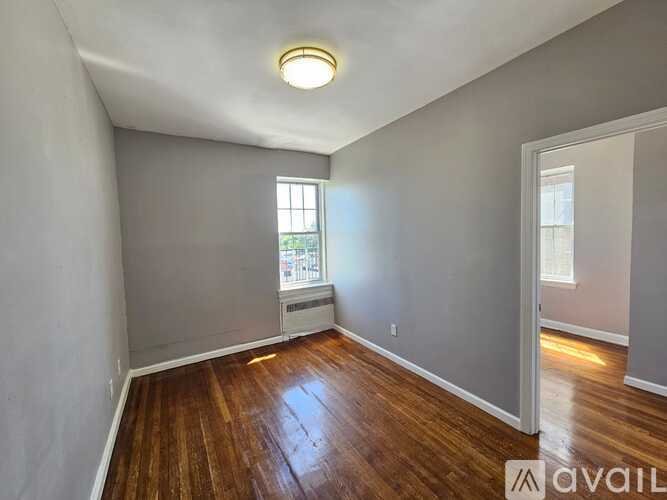 A room with wooden floors and a window.