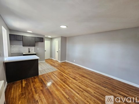 A room with wooden floors and a window.