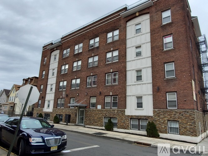 A brick building with a white trimmed window.