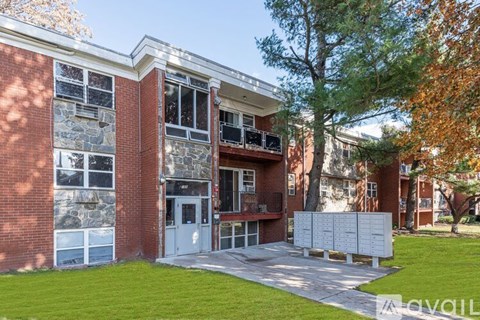 A red brick building with a white door and windows.