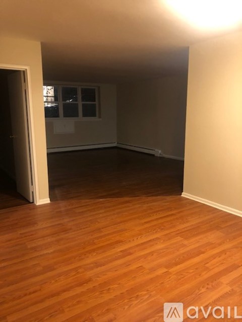 A room with wooden floors and a window.