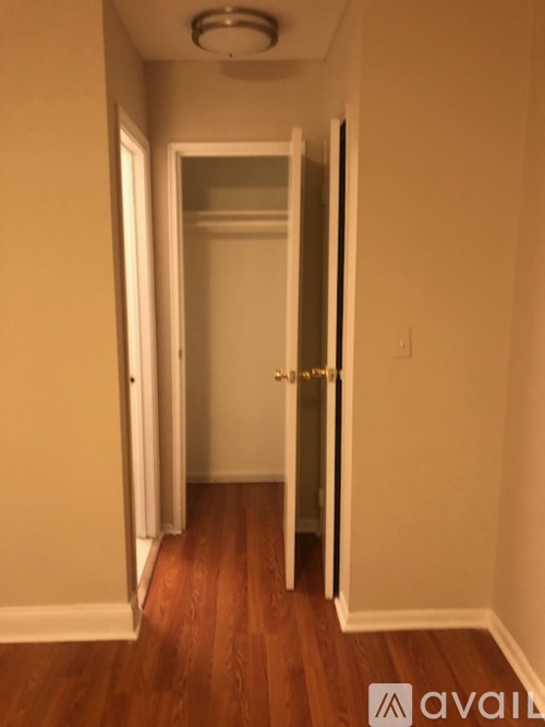 A hallway with a door on the left and another door on the right.