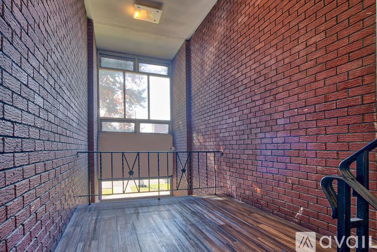 A room with a brick wall and a wooden floor.