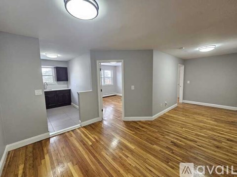 A room with wooden floors and white walls.