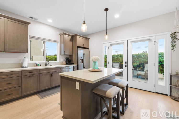 A kitchen with brown cabinets and a white island.
