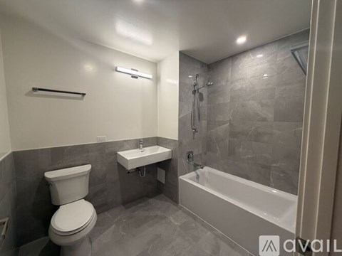 A bathroom with a toilet, sink, and bathtub.