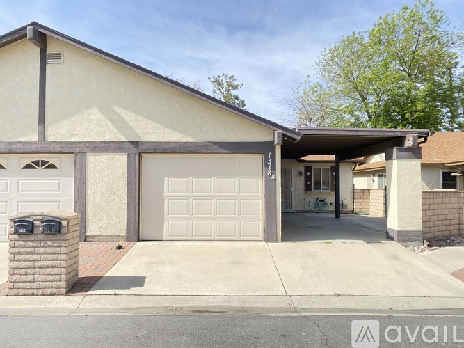 A house with a garage and a driveway in front.