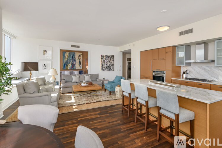 A modern kitchen with a dining table and chairs.