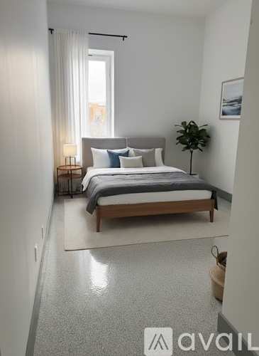 A bedroom with a bed, nightstand, and a plant.