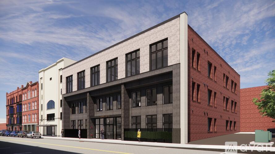 A modern building with a red brick facade and a white section on the left side.