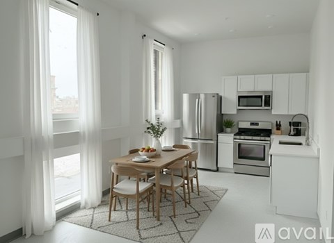 A modern kitchen with a dining table set for two.