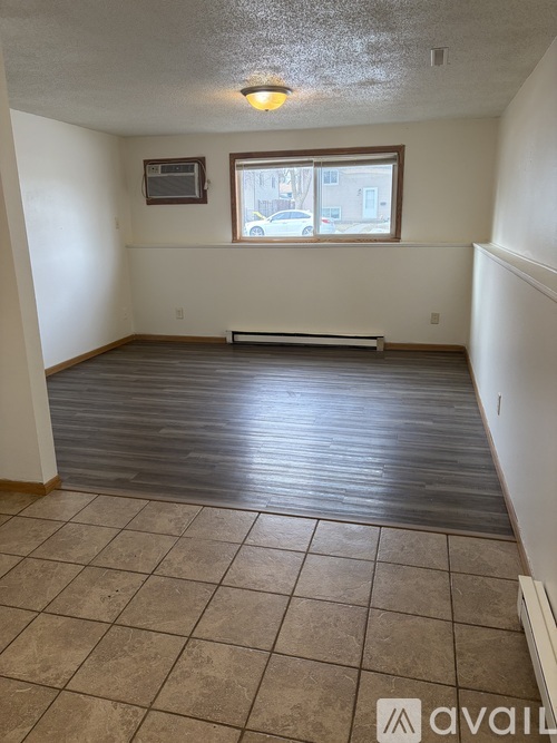 A room with a tiled floor and a window.