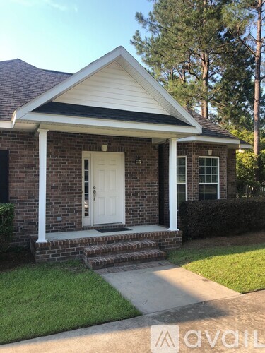 A small house with a white door and a small porch.