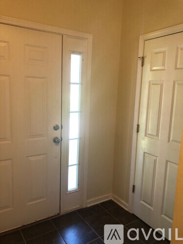 A hallway with two doors and a window.