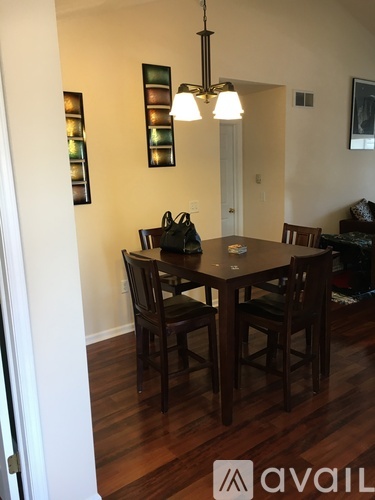 A dining room with a table and chairs.