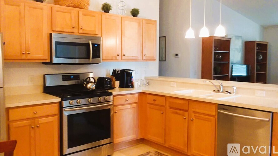 A kitchen with wooden cabinets and a black stove top oven.
