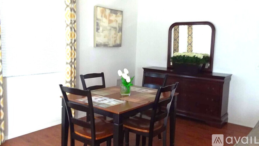A dining room with a wooden table and chairs.