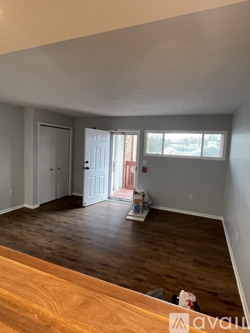 A room with wooden floors and a white door.