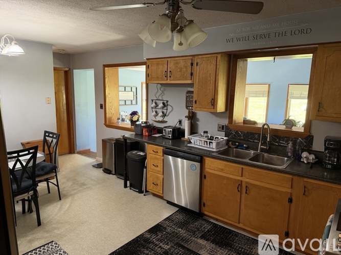 A kitchen with wooden cabinets and a black countertop.