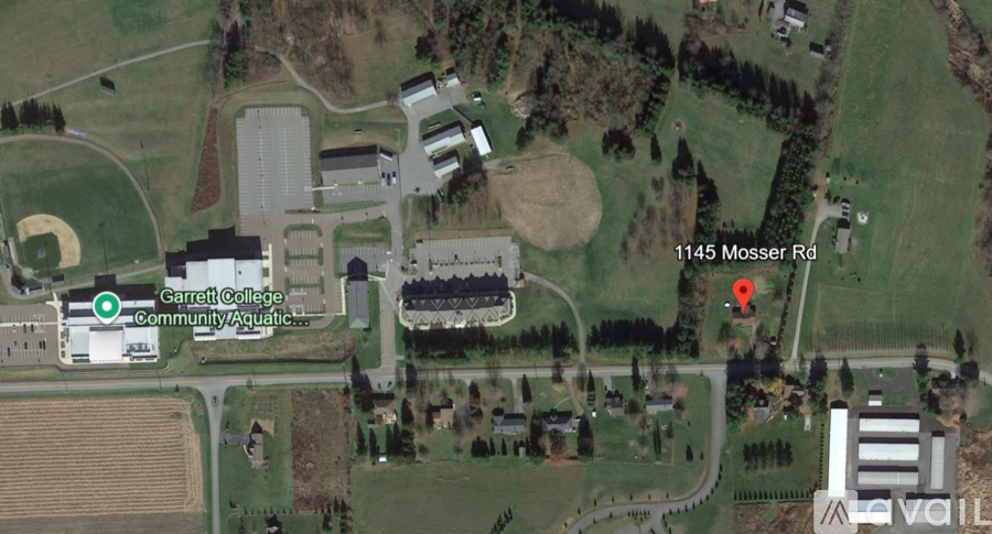 A satellite image shows a college, a community aquatic center, and a baseball field.