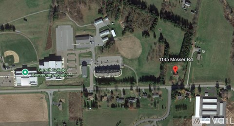 A satellite image shows a college, a community aquatic center, and a baseball field.