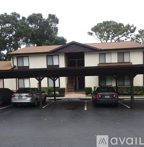 A two-story building with a parking lot in front.