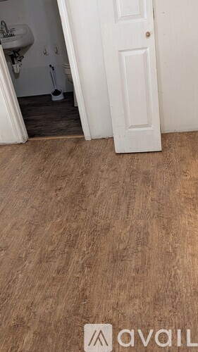 A white door is open to a bathroom.