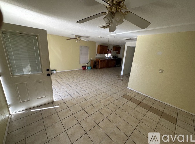 A room with a tiled floor and a ceiling fan.