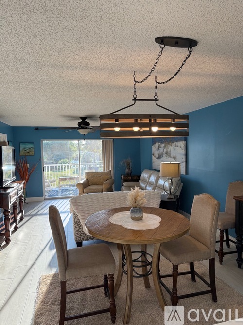 A dining room with a round table and chairs.