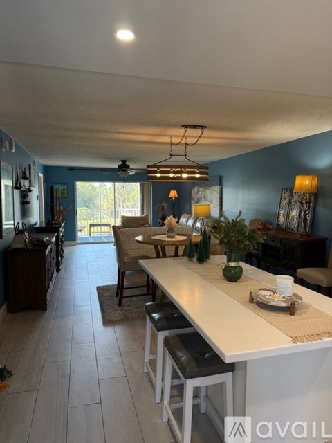 A kitchen with a table and chairs in the middle of the room.