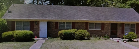 A house with a grey roof and a white door.