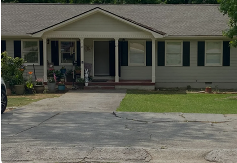 A house with a grey roof and a white porch.