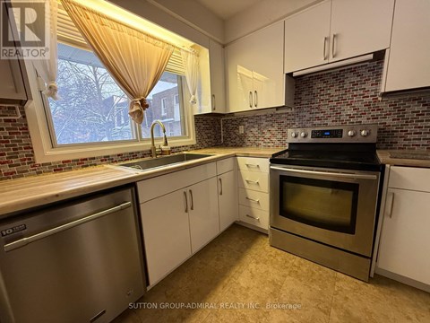 A kitchen with a stainless steel dishwasher and oven.