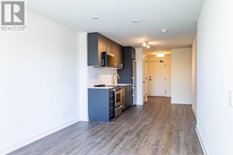 A kitchen with a blue cabinet and a white wall.