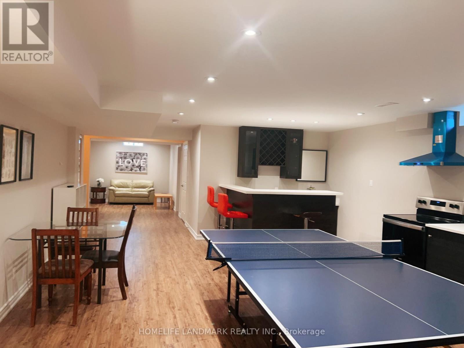 A ping pong table is in the middle of a living room.