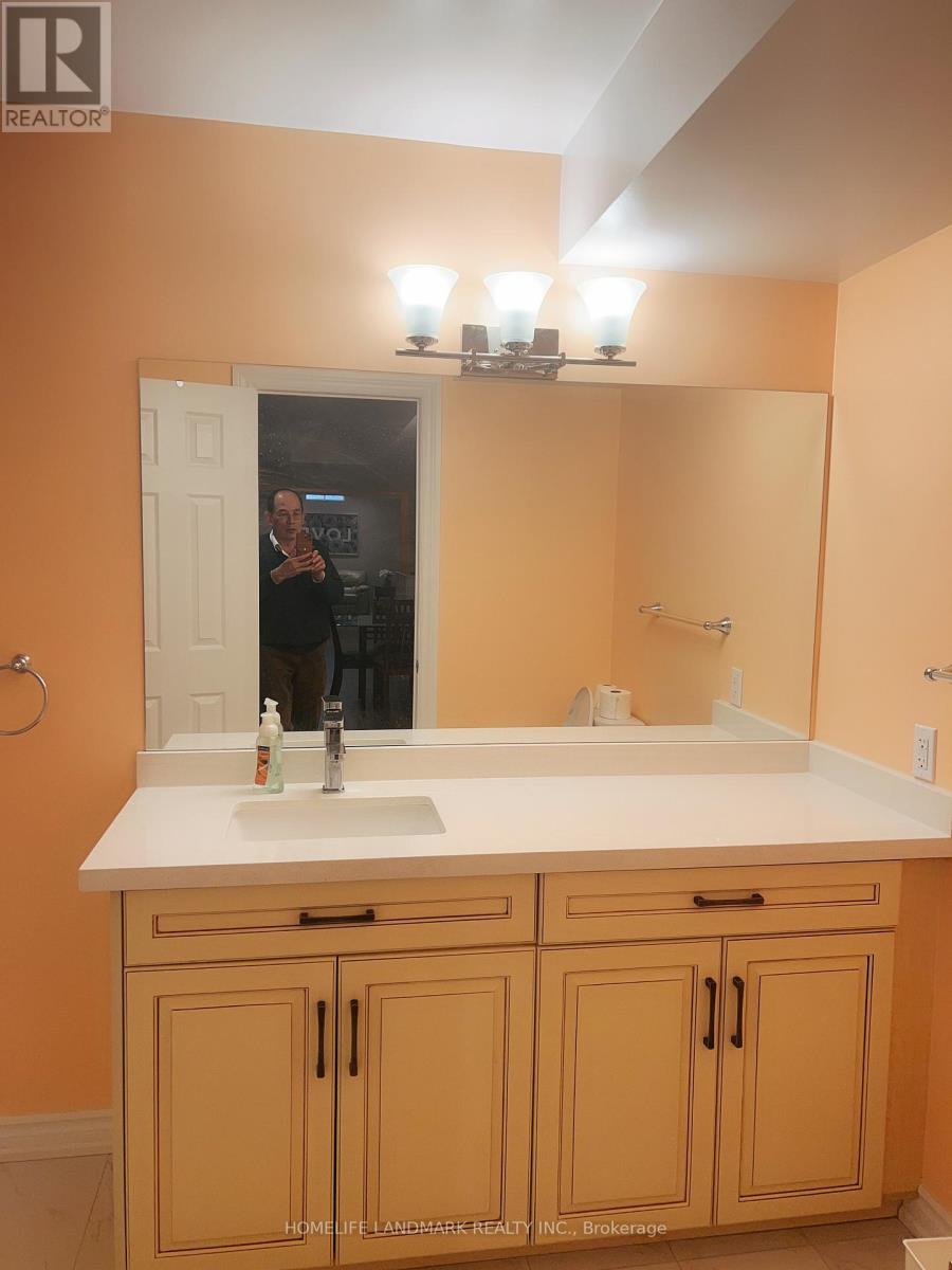 A bathroom with a sink, mirror, and cabinets.