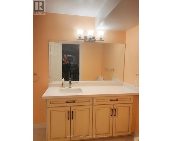 A bathroom with a sink, mirror, and cabinets.