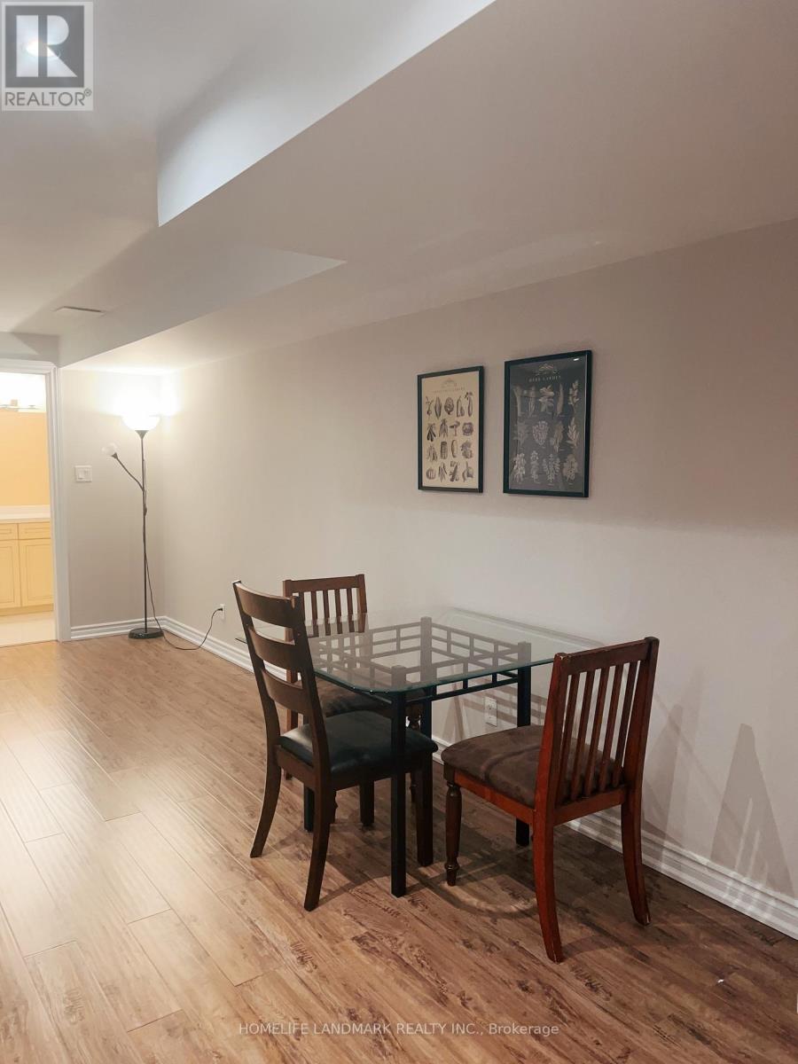 A dining room with a glass table and chairs.