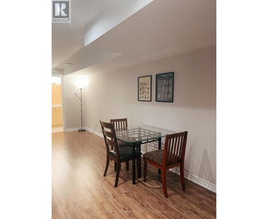 A dining room with a glass table and chairs.