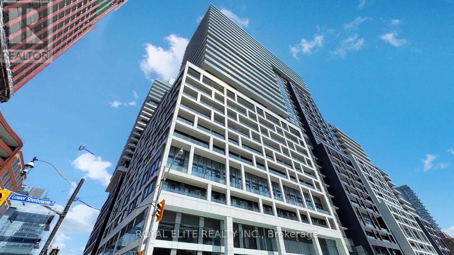 A tall building with the words "REAL ESTATE INC." on the side.