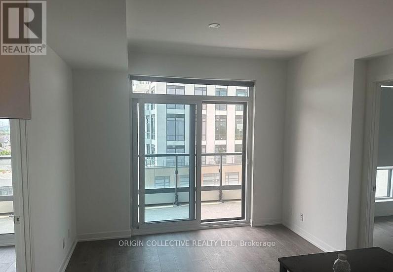 A room with a large window and a table in the foreground.