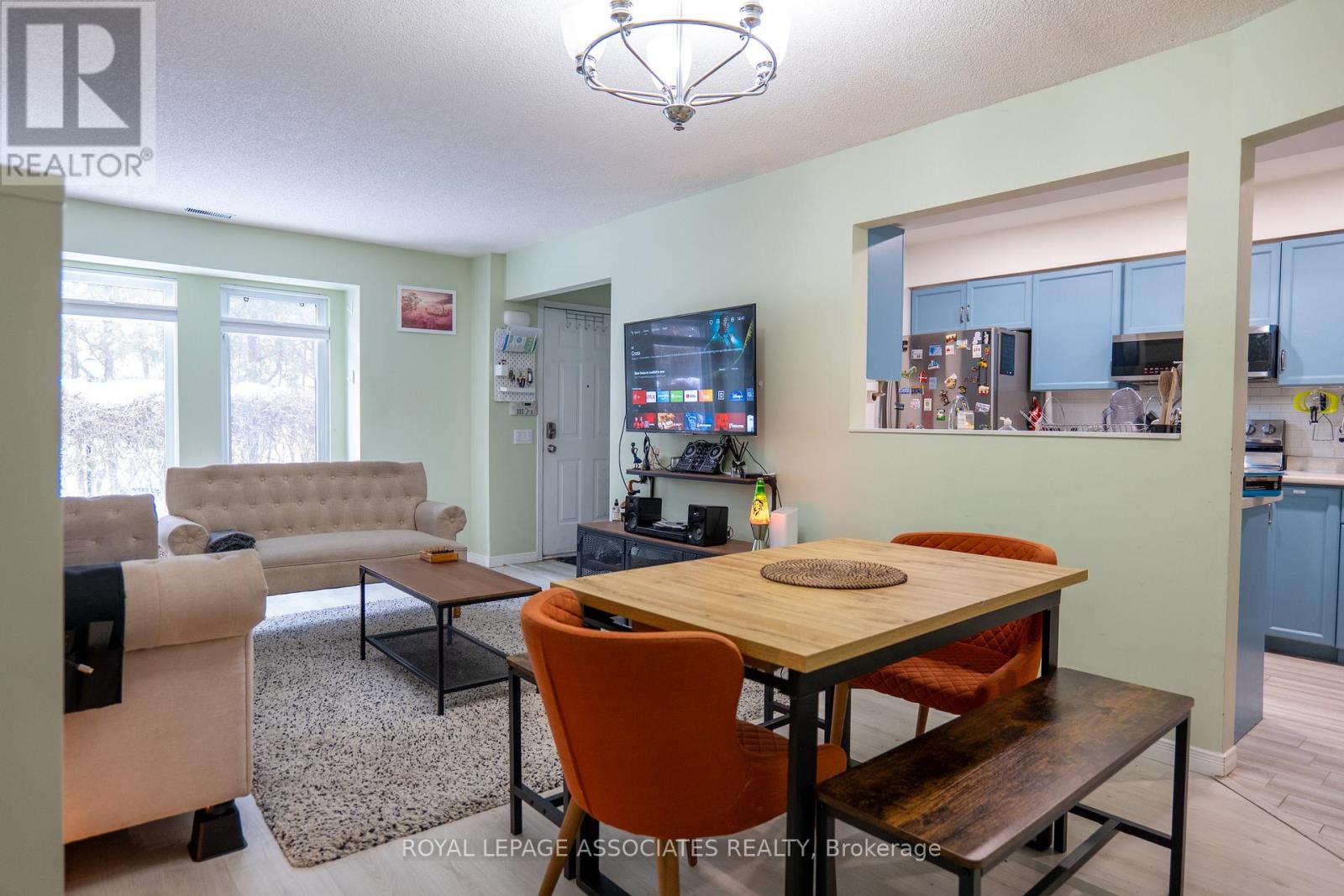 A living room with a couch, a coffee table, and a television.