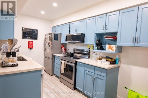 A kitchen with blue cabinets and a white countertop.