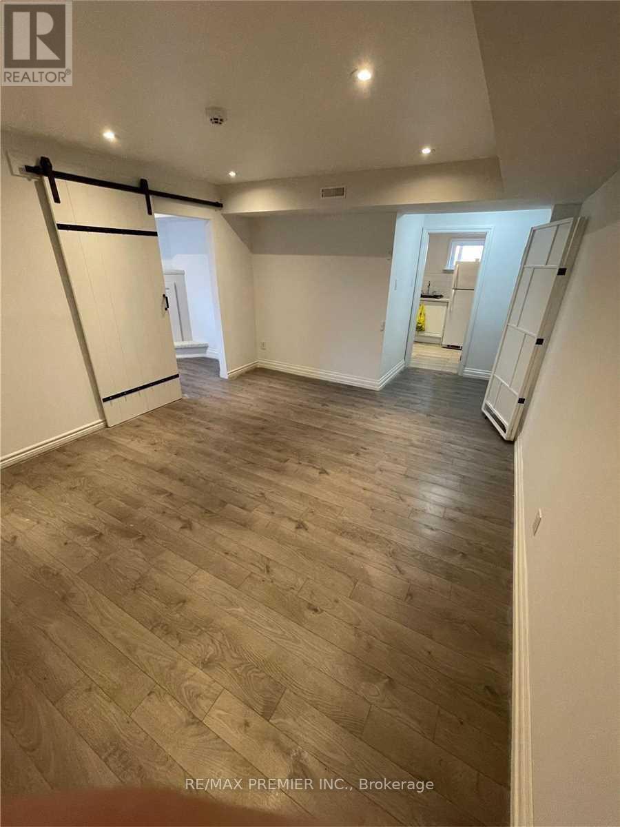 A room with wood flooring and a sliding door.