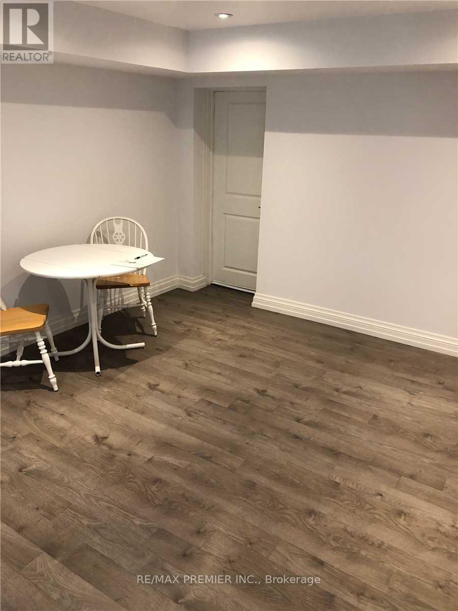 A room with a white table and chairs.