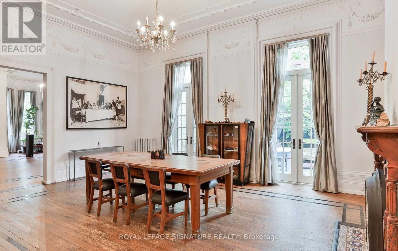 A large, elegant dining room with a wooden table and chairs.