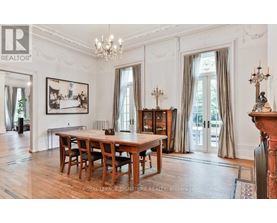 A large, elegant dining room with a wooden table and chairs.