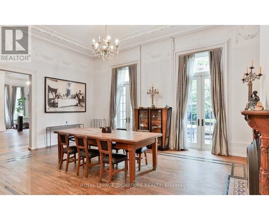 A large, elegant dining room with a wooden table and chairs.